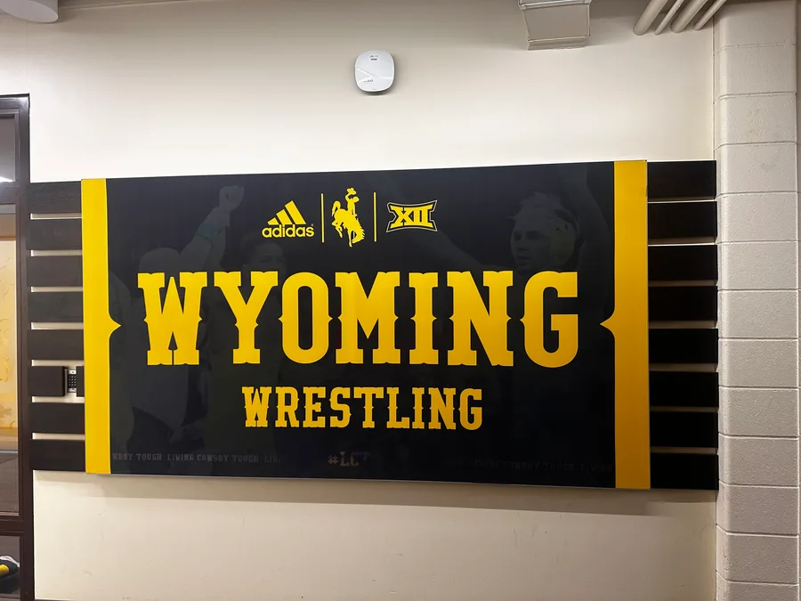 Printed Wyoming Wrestling wall banner installed in a university facility